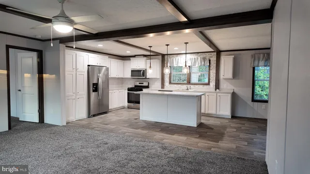 a kitchen with stainless steel appliances a stove a sink and a microwave