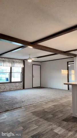 a large kitchen with a large window stainless steel appliances and cabinets
