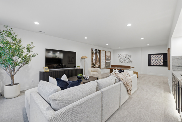 2559 West Aurora Avenue Mapleton, UT 84664 - Photo 53 of 60 Spacious living area featuring recessed lighting, light-toned carpeting, a built-in wet bar with a stone countertop, and a dark wood-finish media console