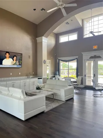 a living room with furniture and a large window