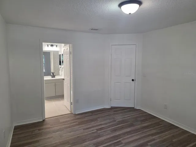 a view of a room with wooden floor and bathroom