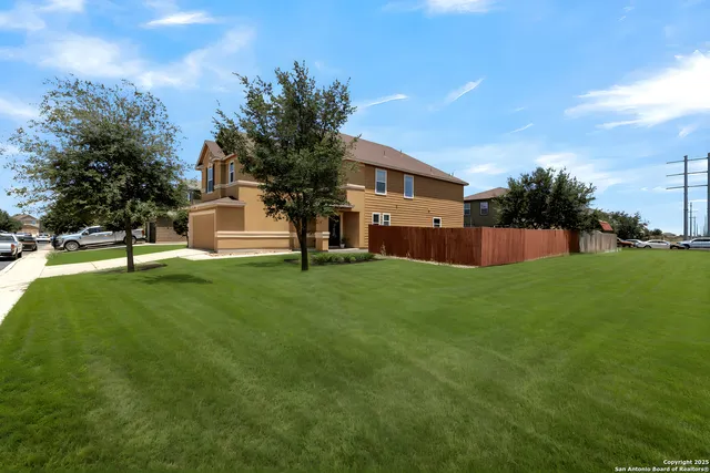 a view of a house with a backyard