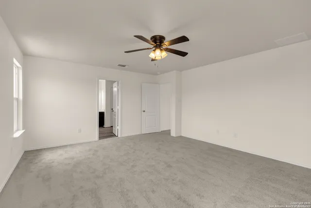 a bathroom with a tub a double vanity sink and a mirror