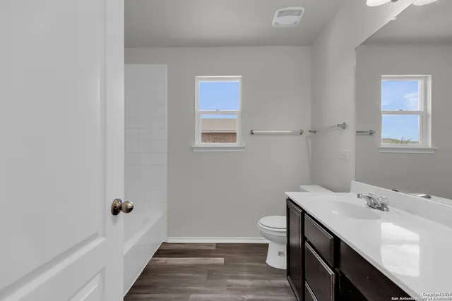 a bathroom with a sink a toilet and a mirror