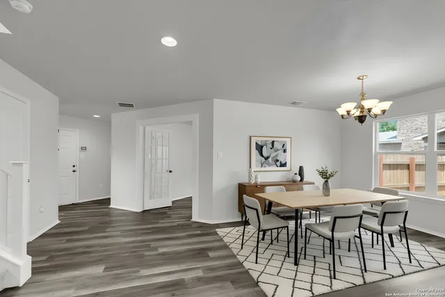 a view of a dining room with furniture and wooden floor
