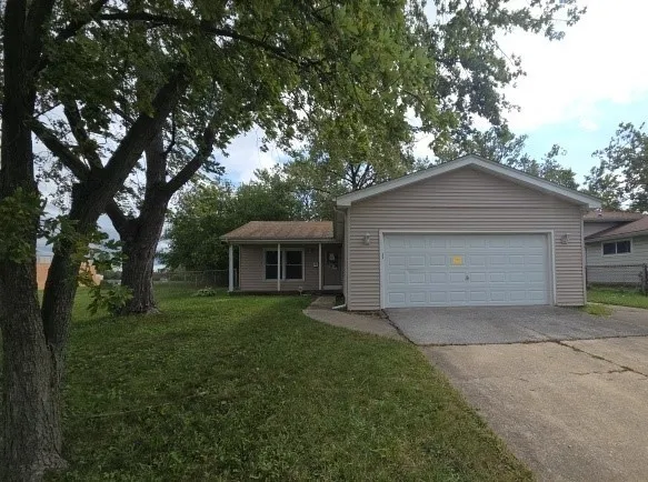 a front view of house with yard and trees