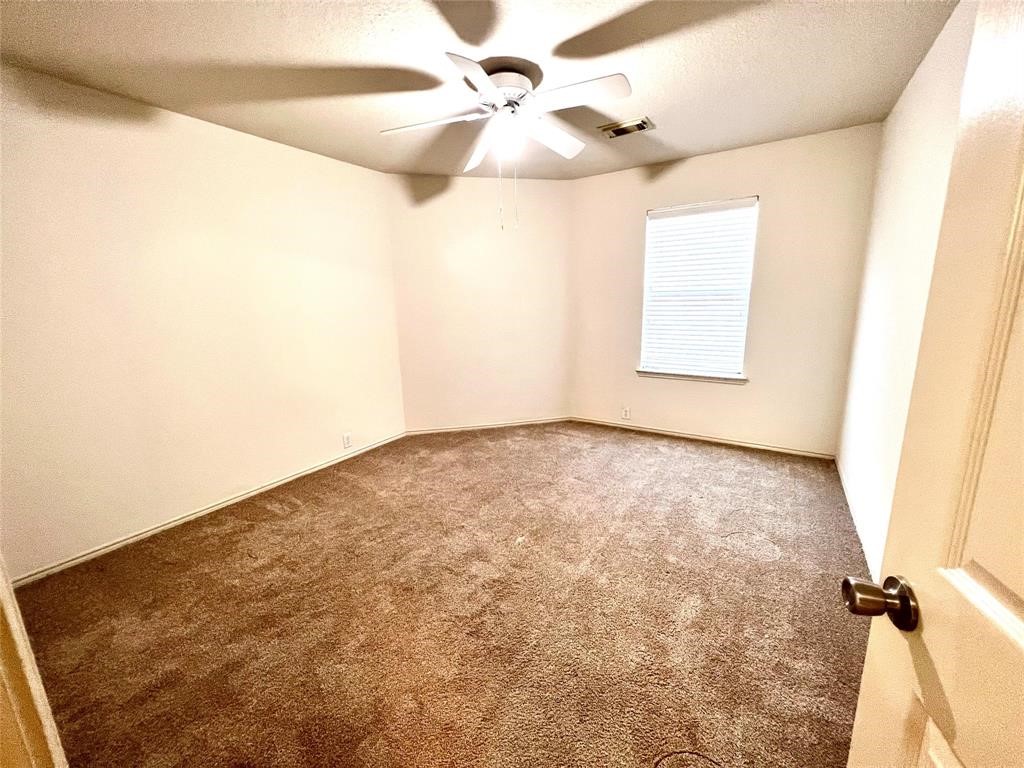 10219 Sugarbridge Trail Sugar Land, TX 77498 - Photo 12 of 16 an empty room with a window and a fan