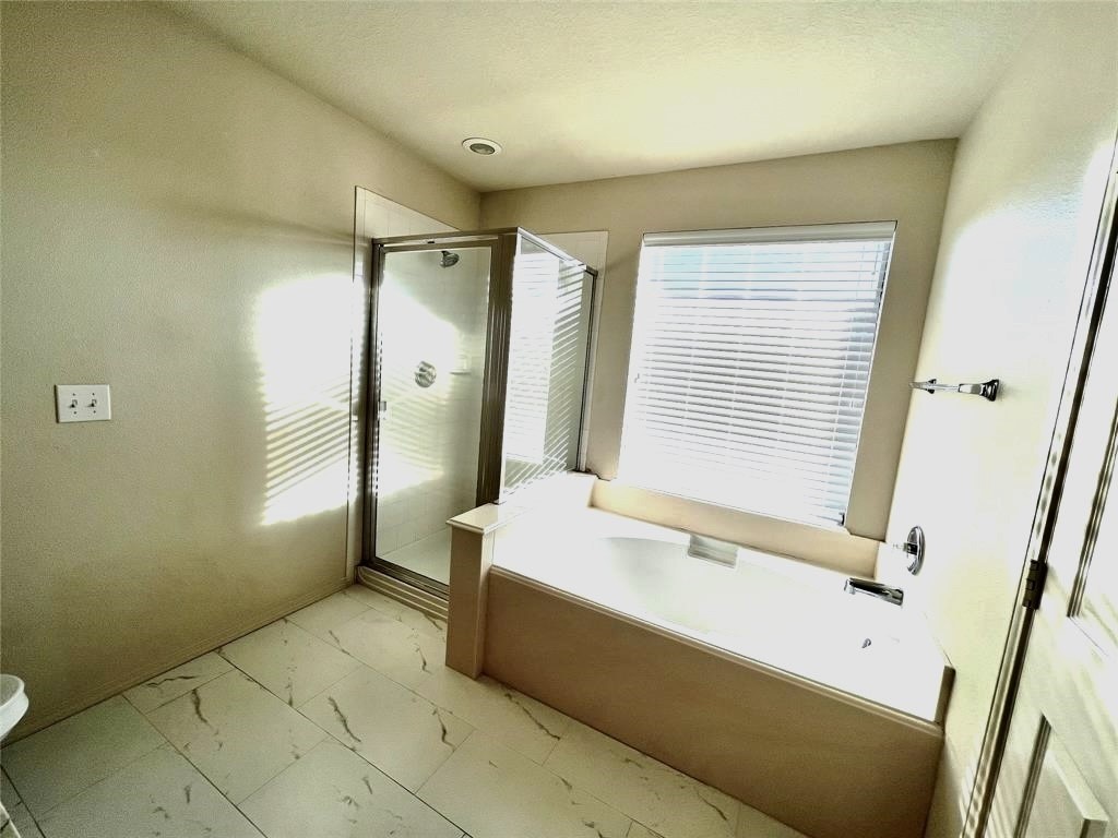 10219 Sugarbridge Trail Sugar Land, TX 77498 - Photo 15 of 16 a spacious bathroom with a tub sink and shower