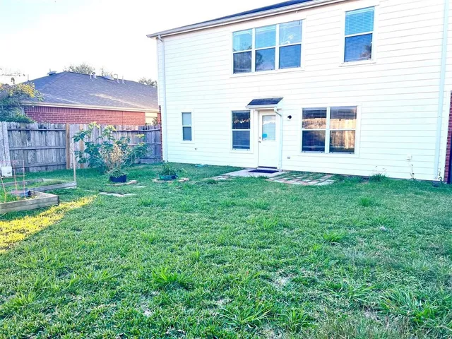 a view of a house with a yard and sitting area