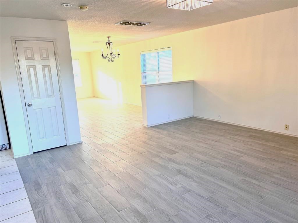 10219 Sugarbridge Trail Sugar Land, TX 77498 - Photo 9 of 16 an empty room with wooden floor and windows