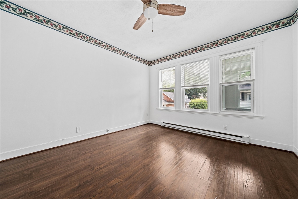 62 Favre Street, Unit 2 Boston, MA 02126 - Photo 11 of 24 a view of an empty room with a window and wooden floor