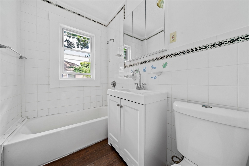 62 Favre Street, Unit 2 Boston, MA 02126 - Photo 12 of 24 a bathroom with a tub a sink and a toilet