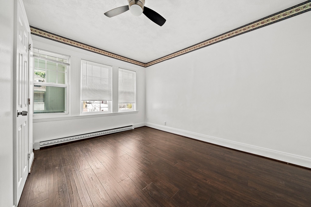 62 Favre Street, Unit 2 Boston, MA 02126 - Photo 16 of 24 an empty room with wooden floor and windows