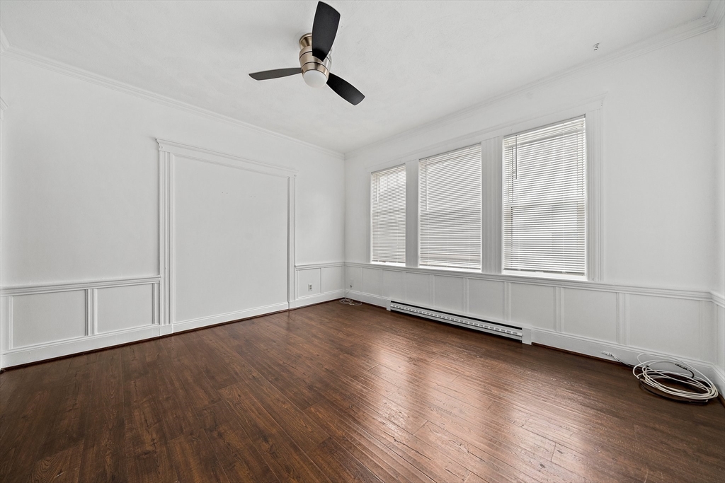 62 Favre Street, Unit 2 Boston, MA 02126 - Photo 18 of 24 wooden floor in an empty room with a window