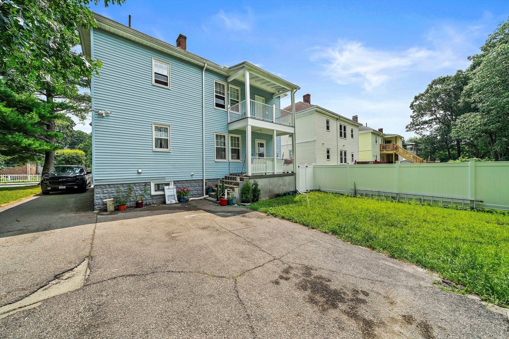 62 Favre Street, Unit 2 Boston, MA 02126 - Photo 23 of 24 a front view of a house with a yard and garage