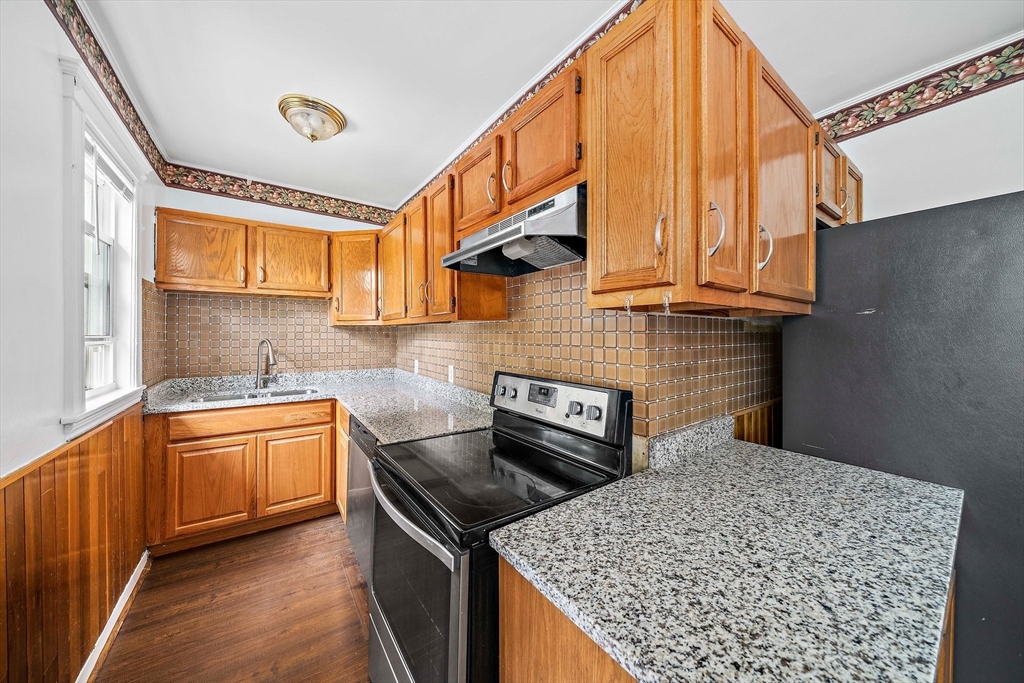 62 Favre Street, Unit 2 Boston, MA 02126 - Photo 5 of 24 a kitchen with stainless steel appliances granite countertop a stove a sink and a microwave