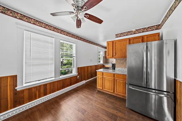 a kitchen with stainless steel appliances a refrigerator and a window