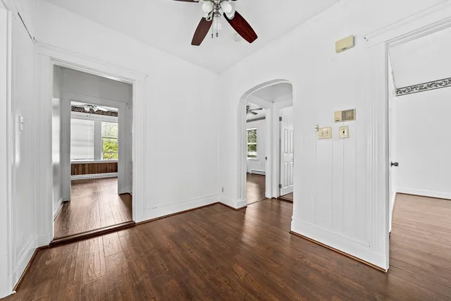 wooden floor in an empty room with a window