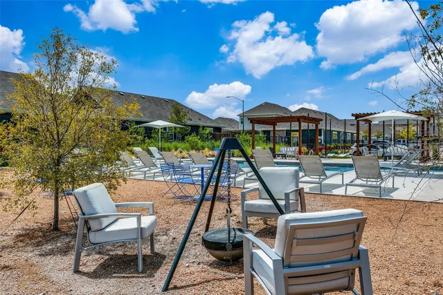 a view of a patio with a dining table and chairs