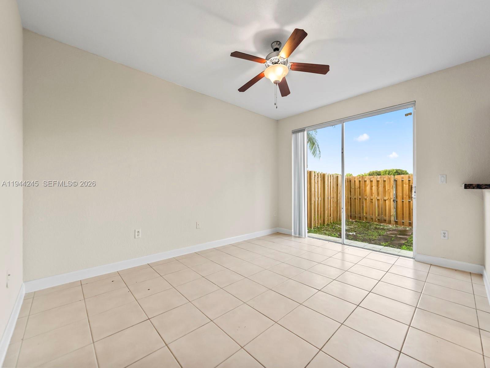 2441 Southeast 14 Street Homestead, FL 33035 - Photo 11 of 32 an empty room with windows and fan