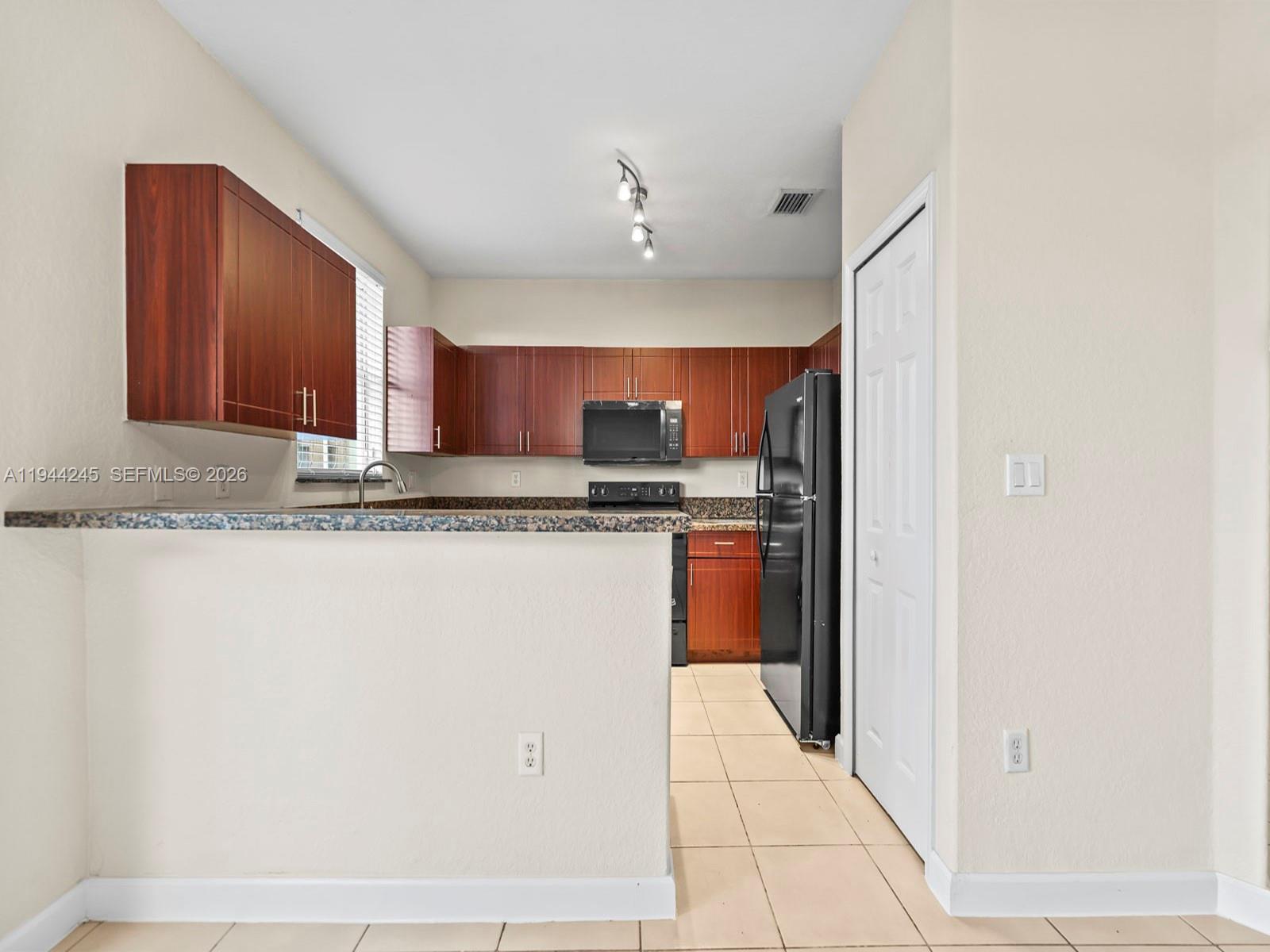 2441 Southeast 14 Street Homestead, FL 33035 - Photo 13 of 32 a view of kitchen with stainless steel appliances granite countertop refrigerator sink and cabinets
