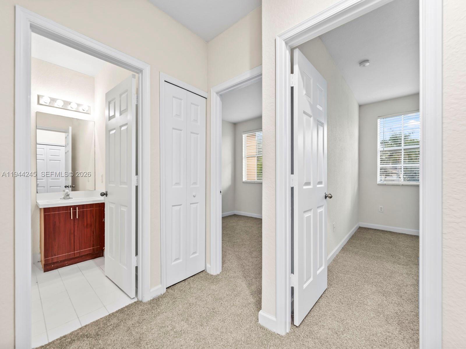 2441 Southeast 14 Street Homestead, FL 33035 - Photo 19 of 32 wooden floor with a bathroom and a mirror