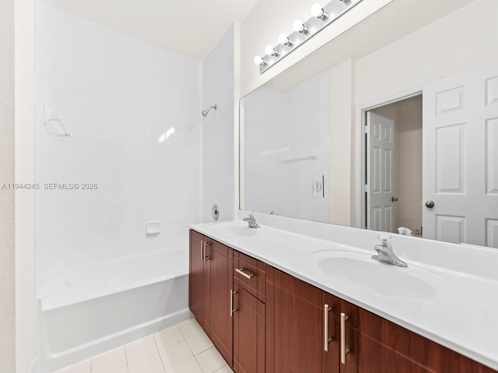 2441 Southeast 14 Street Homestead, FL 33035 - Photo 30 of 32 a bathroom with a sink and a mirror