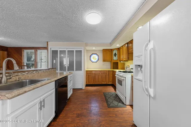 a kitchen with a sink cabinets and stainless steel appliances