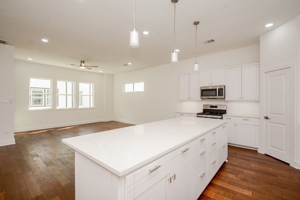 426 Sikes Street, Unit B Houston, TX 77018 - Photo 11 of 31 The island is full of deep drawers for storage, all the cabinetry was built on site and features soft close drawers and under cabinet lighting.