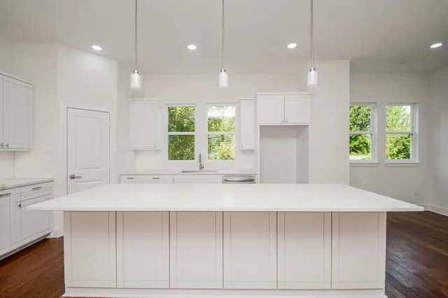 a kitchen with kitchen island a counter space and a window in it