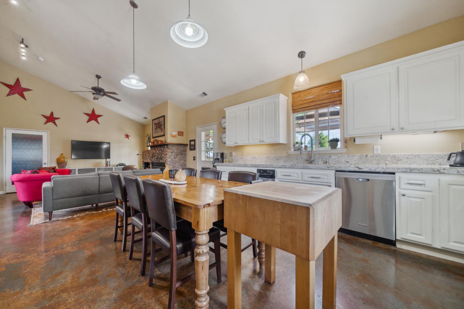 11321 New York Ranch Road Jackson, CA 95642 - Photo 11 of 73 a kitchen that has a lot of cabinets in it with stainless steel appliances granite countertop a stove a sink dishwasher and white cabinets with wooden floor
