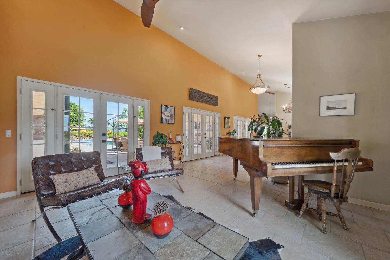 11321 New York Ranch Road Jackson, CA 95642 - Photo 21 of 73 a living room with furniture a rug and a floor to ceiling window