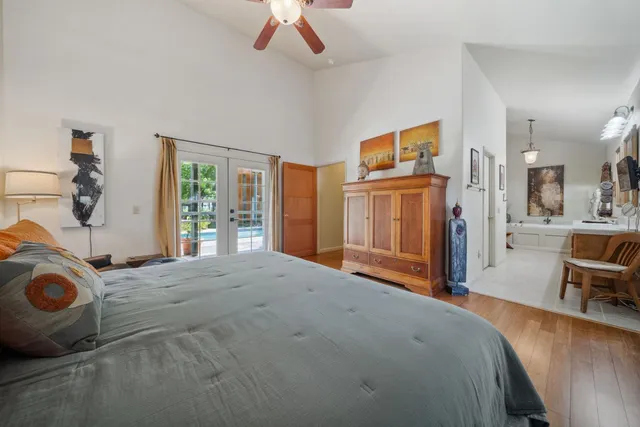 a view of a hallway and wooden floor with a livingroom view