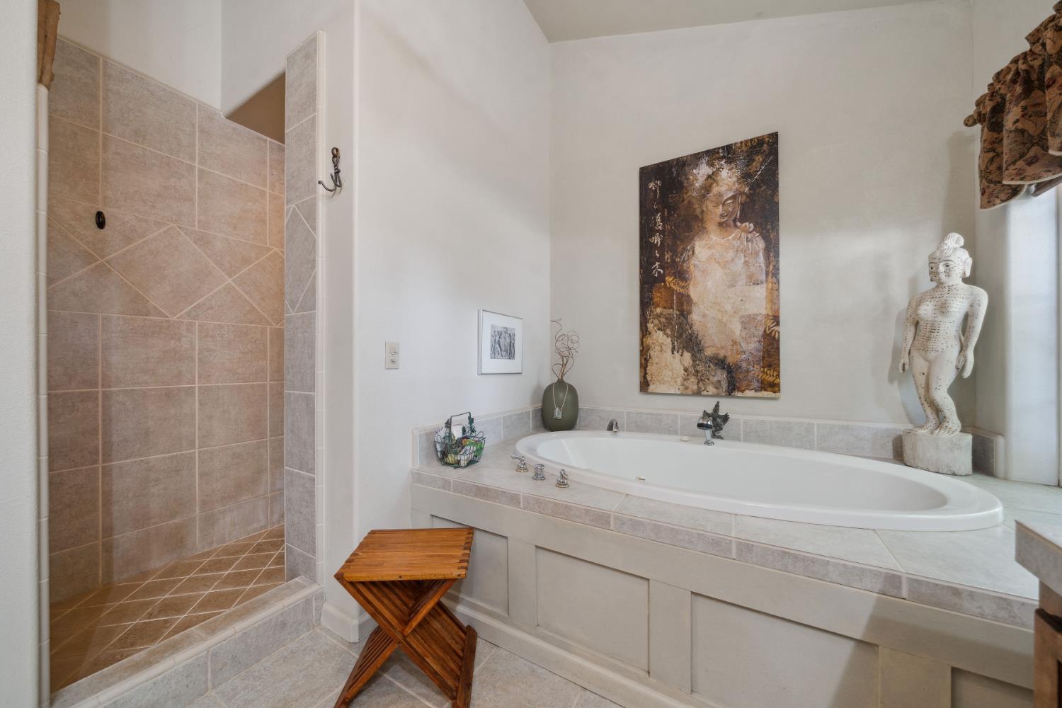 11321 New York Ranch Road Jackson, CA 95642 - Photo 26 of 73 a bathroom with a granite countertop sink a mirror and shower