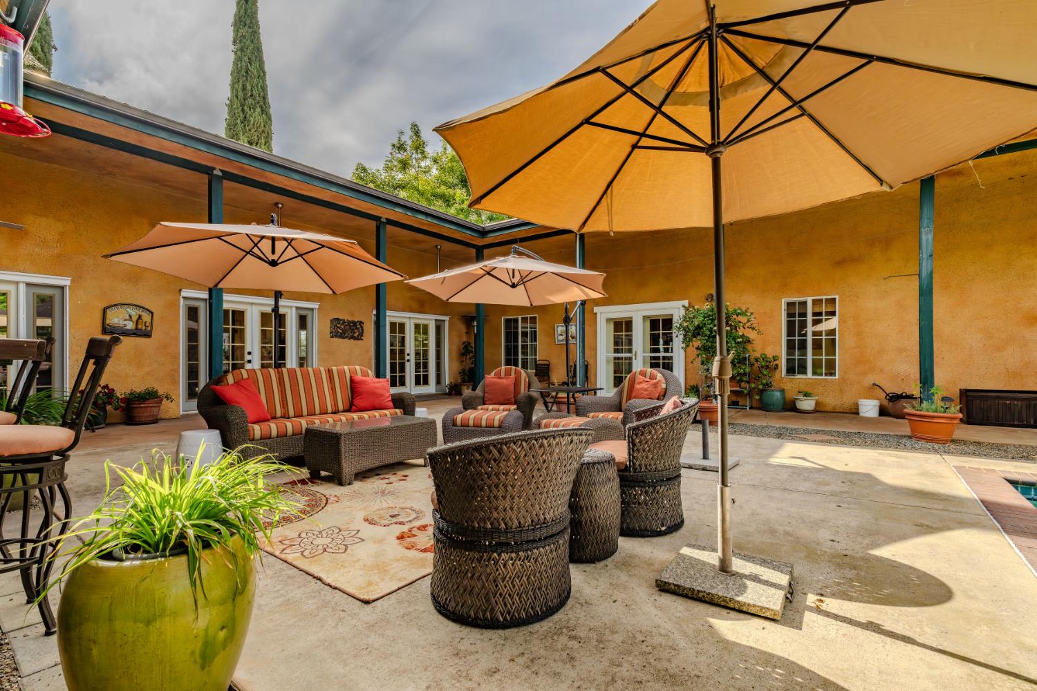 11321 New York Ranch Road Jackson, CA 95642 - Photo 35 of 73 a view of a patio with a table and chairs under an umbrella