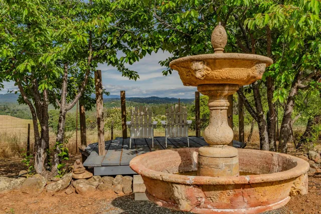 a bed sitting in a bedroom next to a lamp