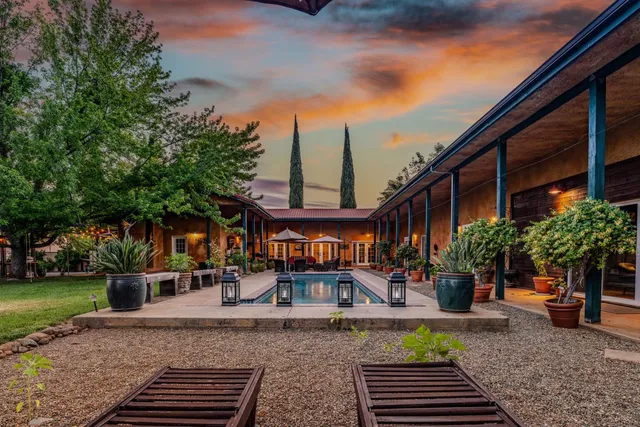a view of a backyard with sitting area
