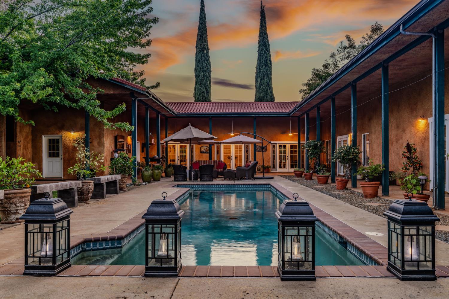 11321 New York Ranch Road Jackson, CA 95642 - Photo 6 of 73 a view of a patio with couches table and chairs with wooden floor fence and roof