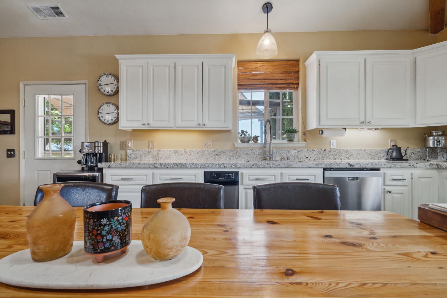 11321 New York Ranch Road Jackson, CA 95642 - Photo 9 of 73 a kitchen with kitchen island granite countertop a stove a sink and a granite counter tops