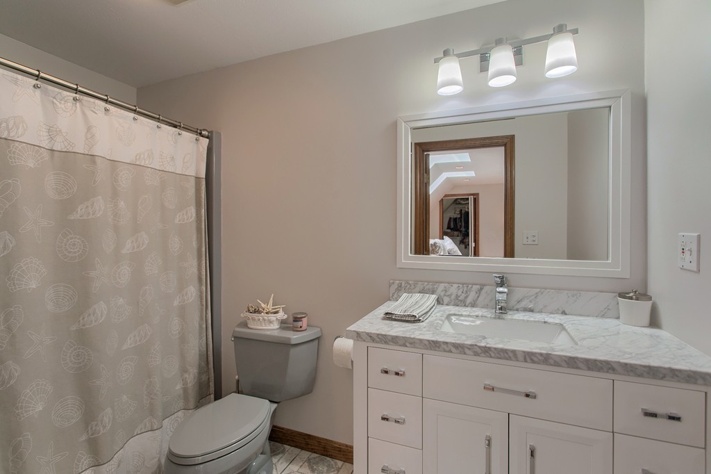 27 Ledge Road Chelmsford, MA 01863 - Photo 19 of 30 a bathroom with a granite countertop sink a toilet and a mirror