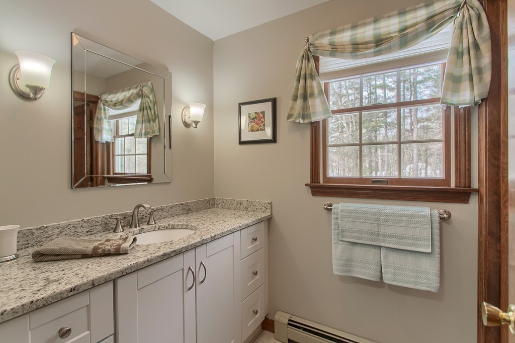 27 Ledge Road Chelmsford, MA 01863 - Photo 23 of 30 a bathroom with a granite countertop sink and mirror with window