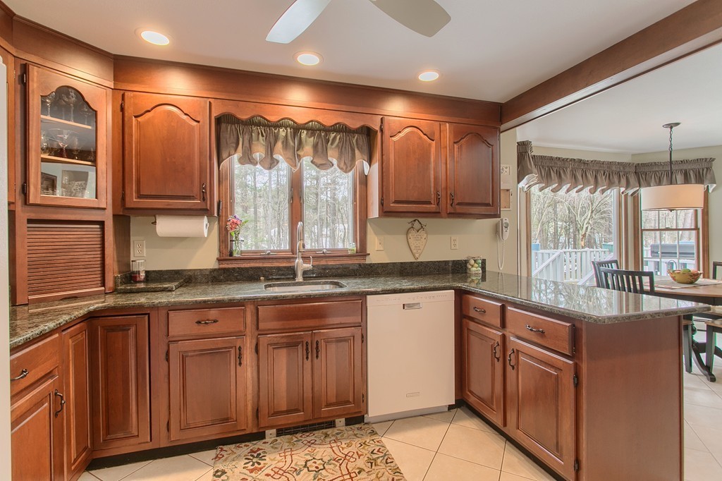 27 Ledge Road Chelmsford, MA 01863 - Photo 3 of 30 a kitchen with stainless steel appliances granite countertop a sink and wooden cabinets