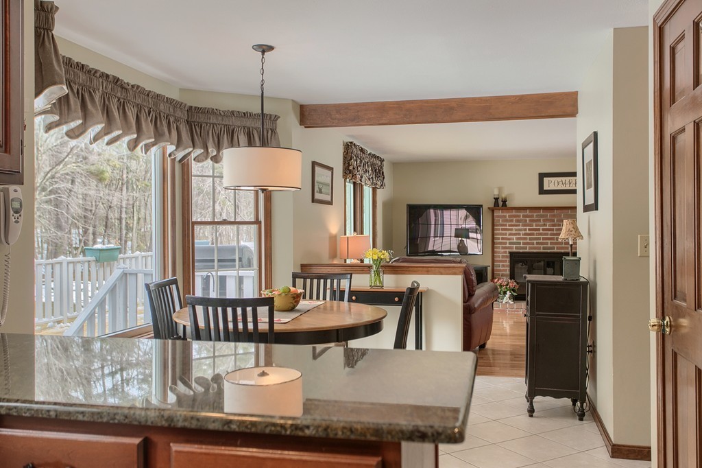 27 Ledge Road Chelmsford, MA 01863 - Photo 4 of 30 a dining room with furniture a chandelier and fireplace