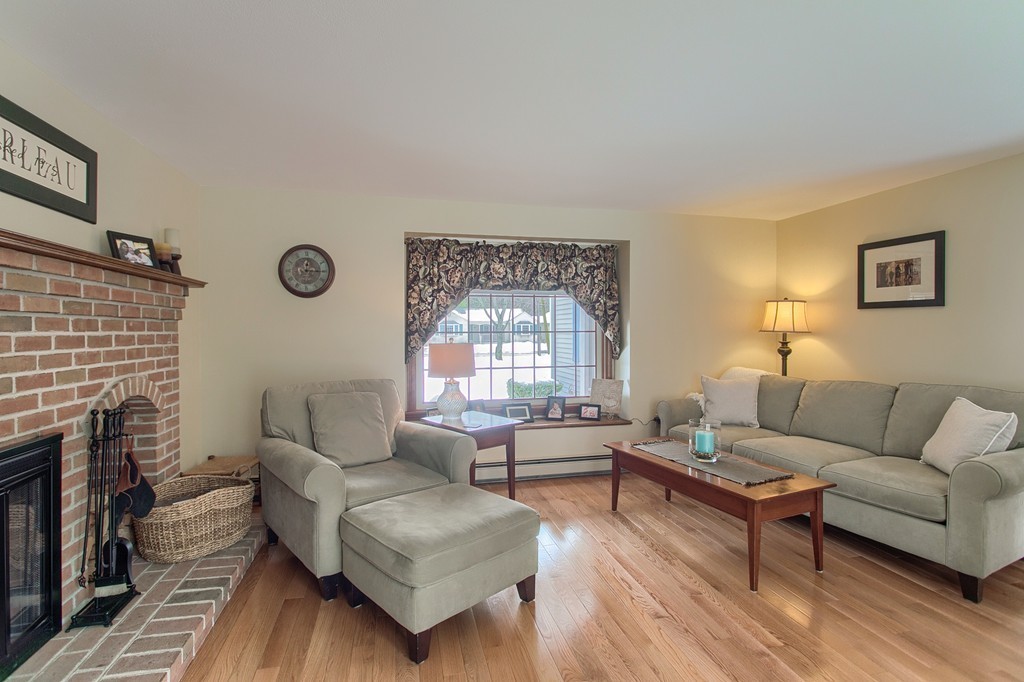 27 Ledge Road Chelmsford, MA 01863 - Photo 6 of 30 a living room with furniture and a fireplace