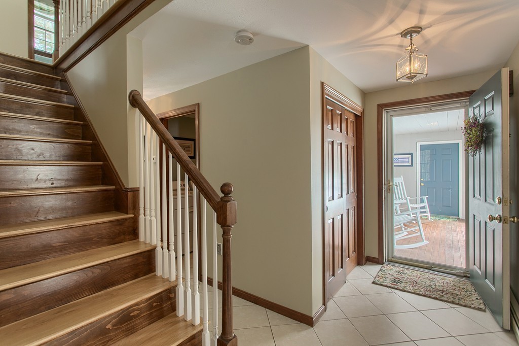 27 Ledge Road Chelmsford, MA 01863 - Photo 10 of 30 a view of a hallway with wooden floor and staircase