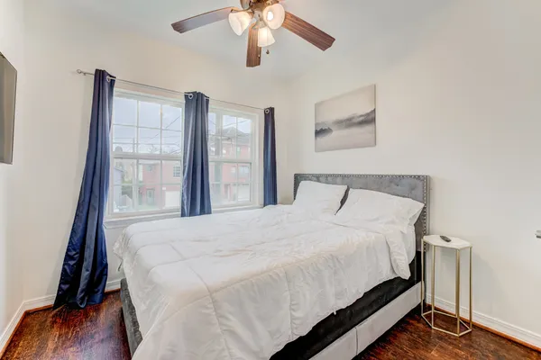 a bedroom with a bed and a large window