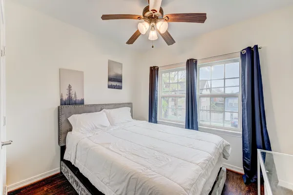 a bedroom with a large bed and a chandelier