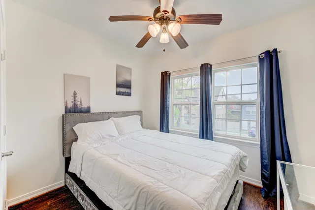 a bedroom with a large bed and a chandelier