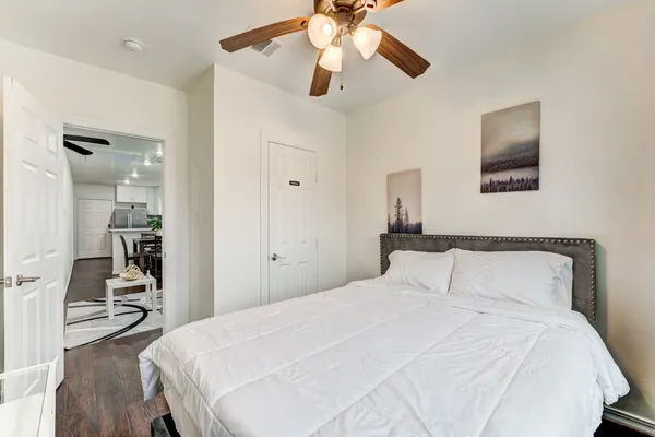 a bedroom with a bed and a chandelier