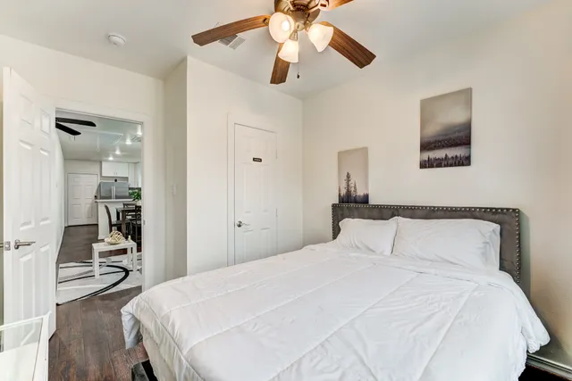 a bedroom with a bed and a chandelier